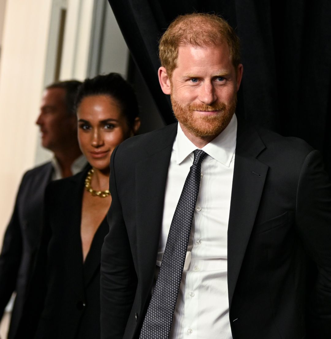 Meghan Markle and Prince harry wearing black suits
