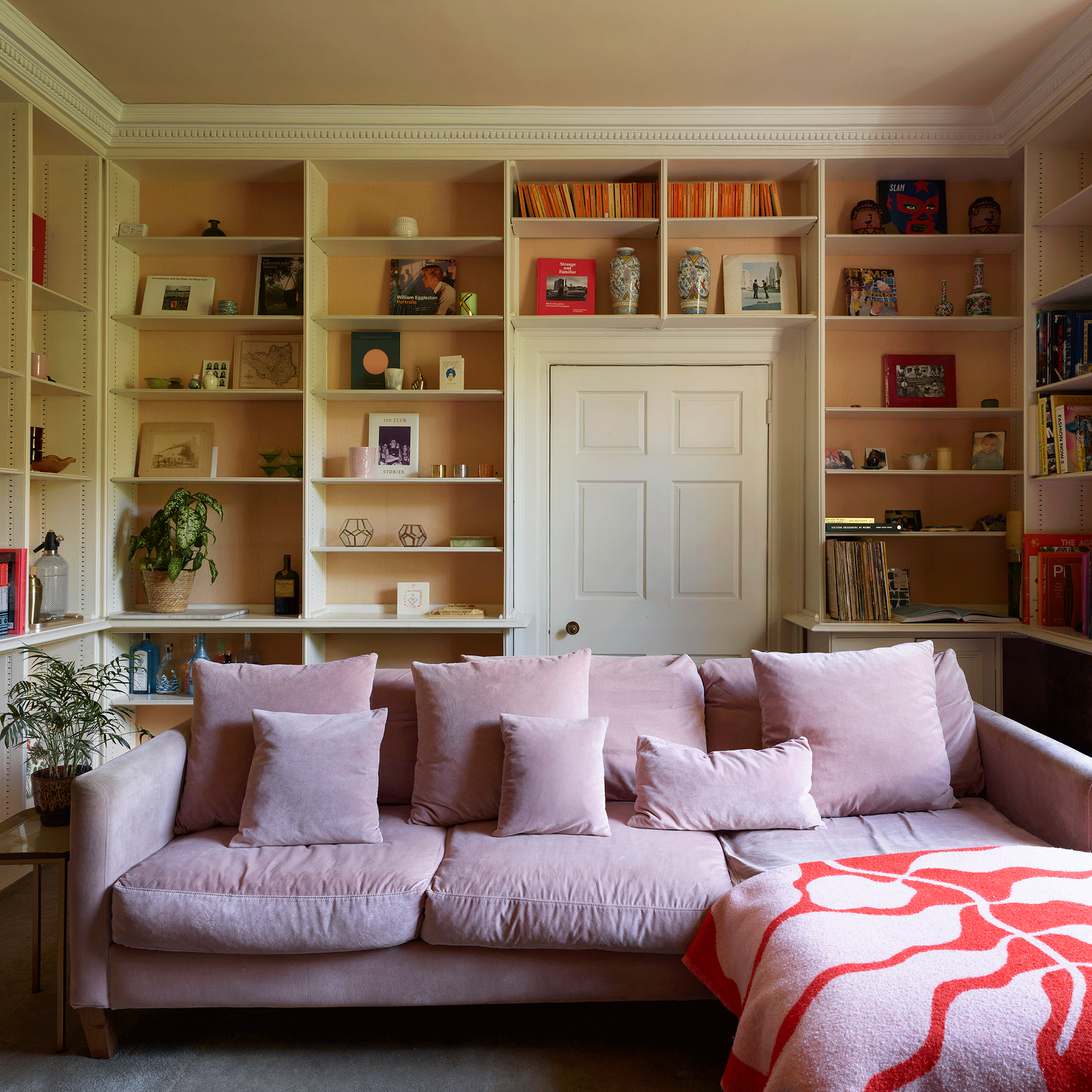 Pink sofa with built in shelves