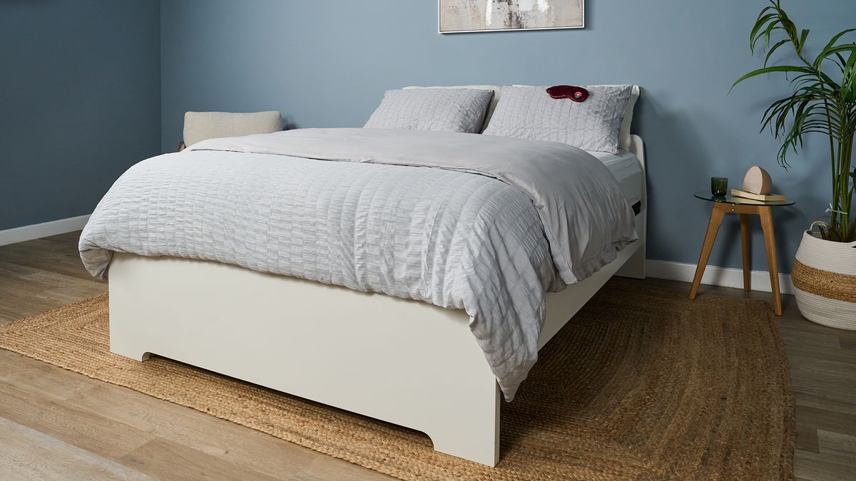 The Helix Midnight Luxe mattress dressed with a comforter and pillows in a matching grey waffle bed set