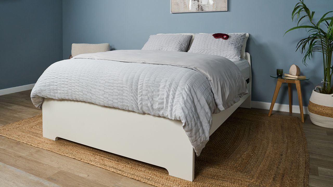 The Helix Midnight Luxe mattress dressed with a comforter and pillows in a matching grey waffle bed set