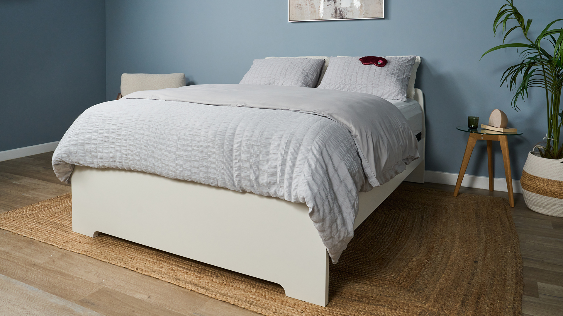 The Helix Midnight Luxe mattress dressed with a comforter and pillows in a matching grey waffle bed set