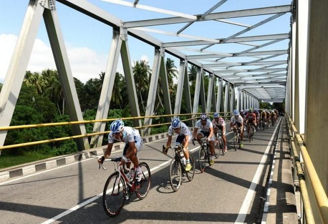 Riders pass through bridge in Lubuk Buaya