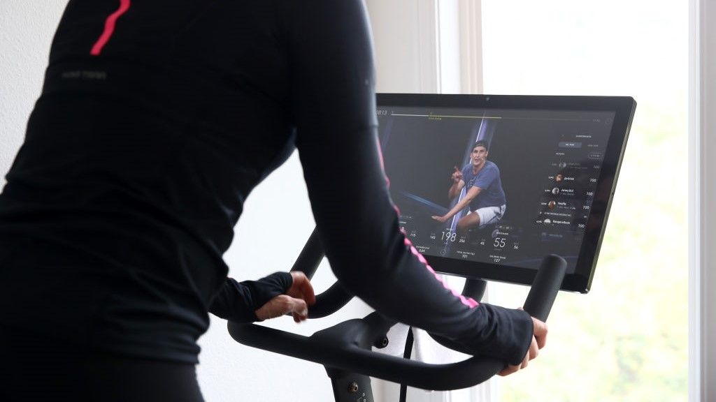 a photo of a woman riding a peloton bike