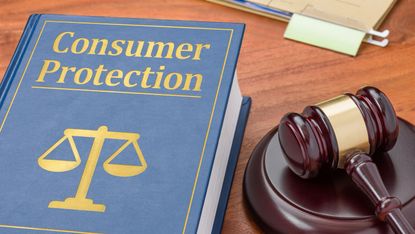 A consumer protection law book lays on a table with a gavel next to it.