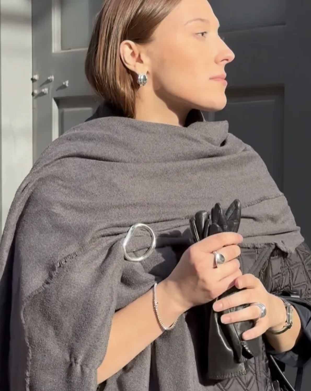 Fashion editor Daneille Naer wears a winter micro trend 2025. She wears a brooch