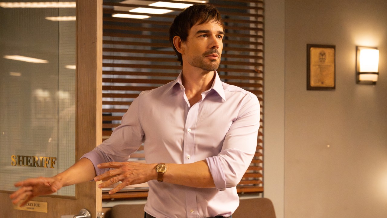 Travis talking with his arms waving to his left in Sheriff Country. 