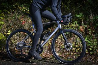 Lower half of a cyclist riding a Ribble Allroad Ti bike wearing black Castelli Soprasso RoS Wind Bibtight