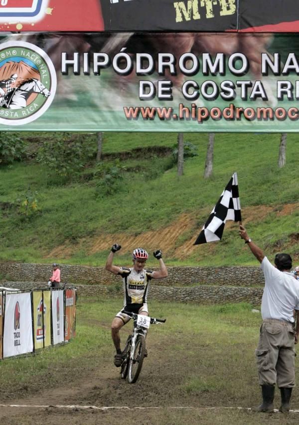 Paulo Vargas (Bufette Guzman Y Alvarez) celebrates winning the Costa Rican cross country national title.