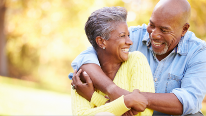 Black mature couple embracing and smiling