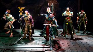 Five distinct fantasy characters stand in a row, each wearing unique, detailed costumes and holding different weapons, set against a dark, industrial background.