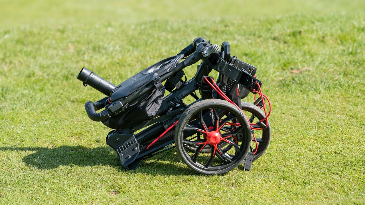 A golfer sets up the Bag Boy Nitron Push Cart