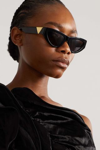 black sunglasses with gold embellishment at the temples
