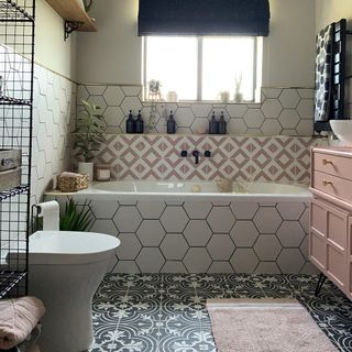 bathroom with white tub and commode