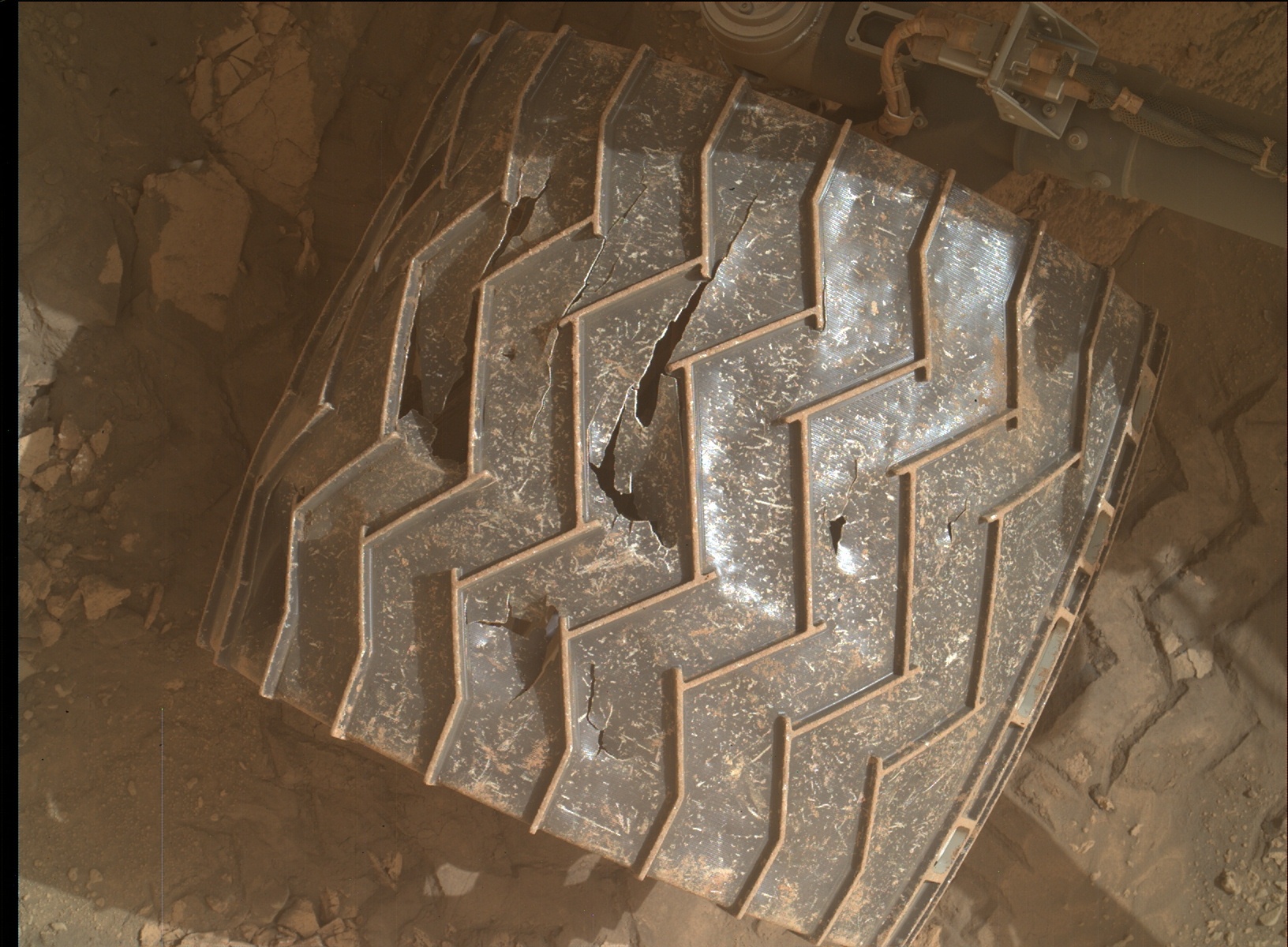 A wheel of the Mars Curiosity rover showing damage from rugged terrain