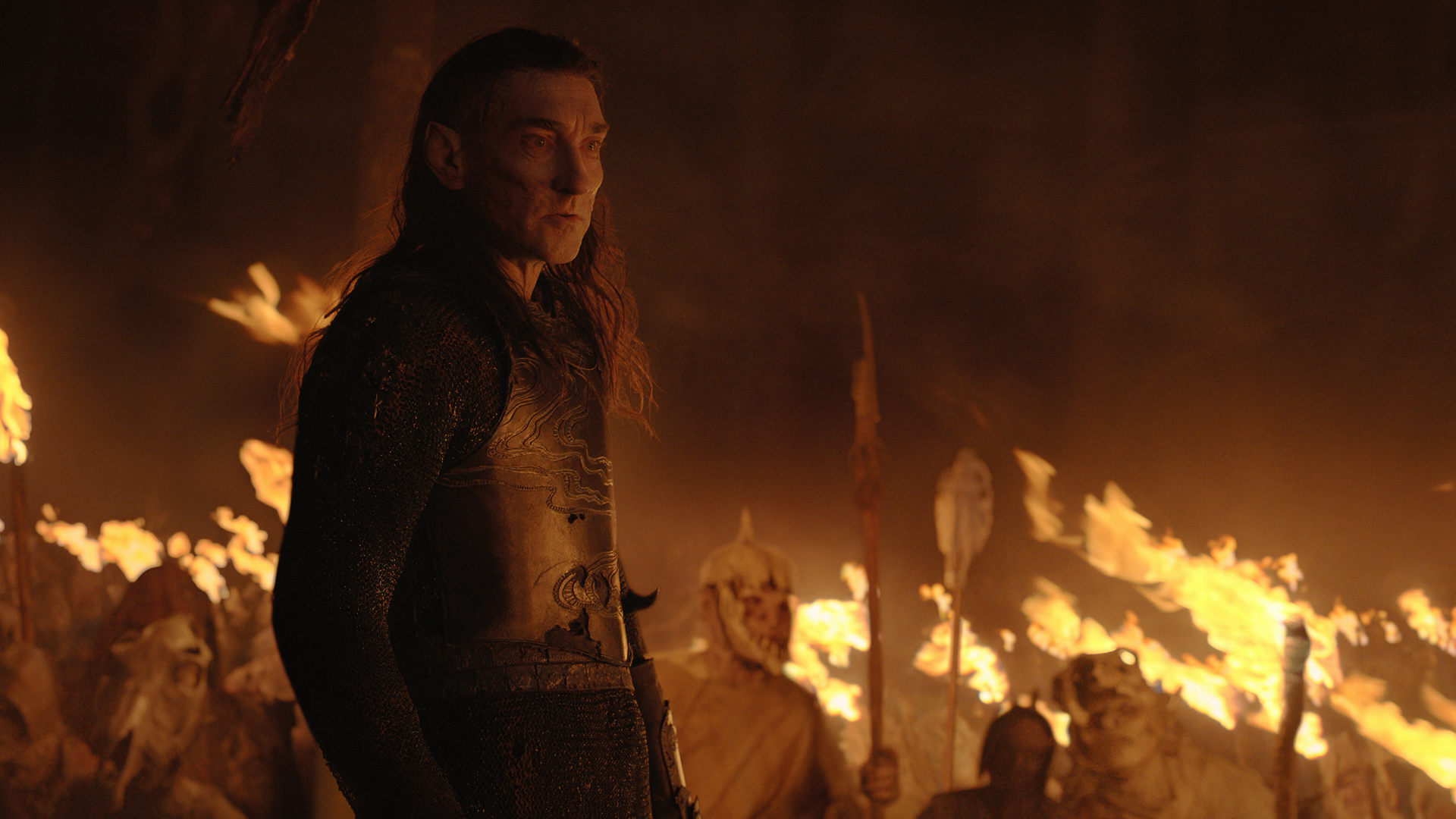 Adar addresses his orc army by fire light in The Rings of Power episode 6