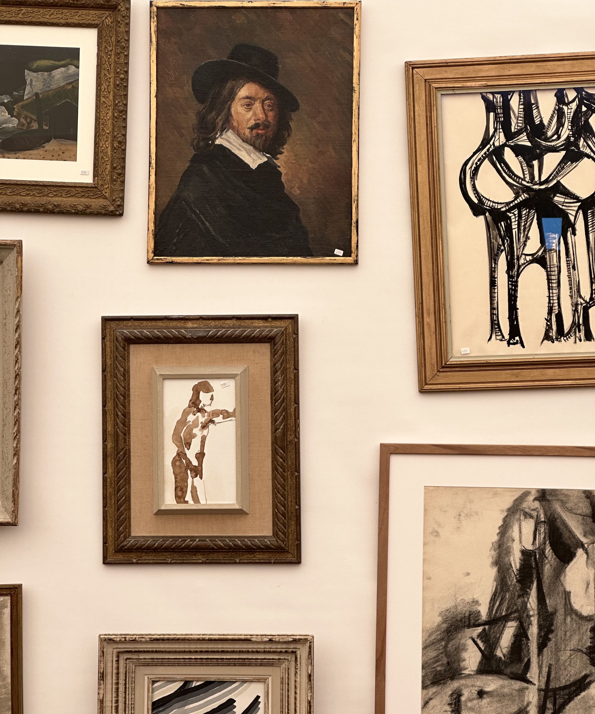 Wall of vintage paintings and prints