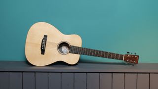 Martin LX1E against a blue wall in our photo studio