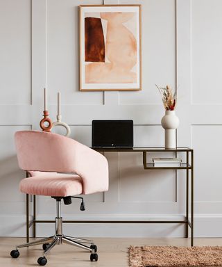 Elegant home office with glass desk and luxe pink velvet office chair