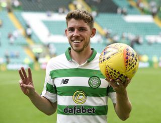 Ryan Christie celebrates with the match ball after his hat-trick