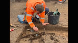 Man excavating metal weapons