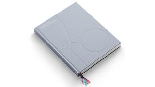 A photo of the book PlayStation: The First 30 years on a white background