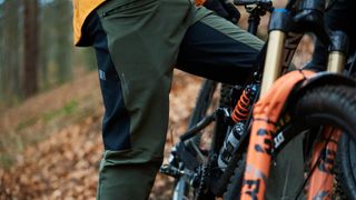 Close up of man's legs by mountain bike
