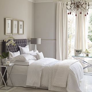 bedroom with white wall and curtains and duvet cover