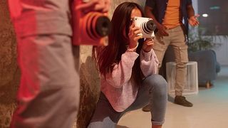 Young woman using a Fujifilm Instax Square SQ1 camera