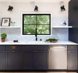 kitchen with dark cabinets and open shelves and white walls
