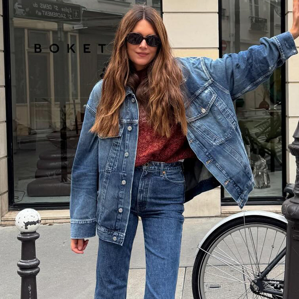 Woman wearing a denim jacket and cigarette jeans