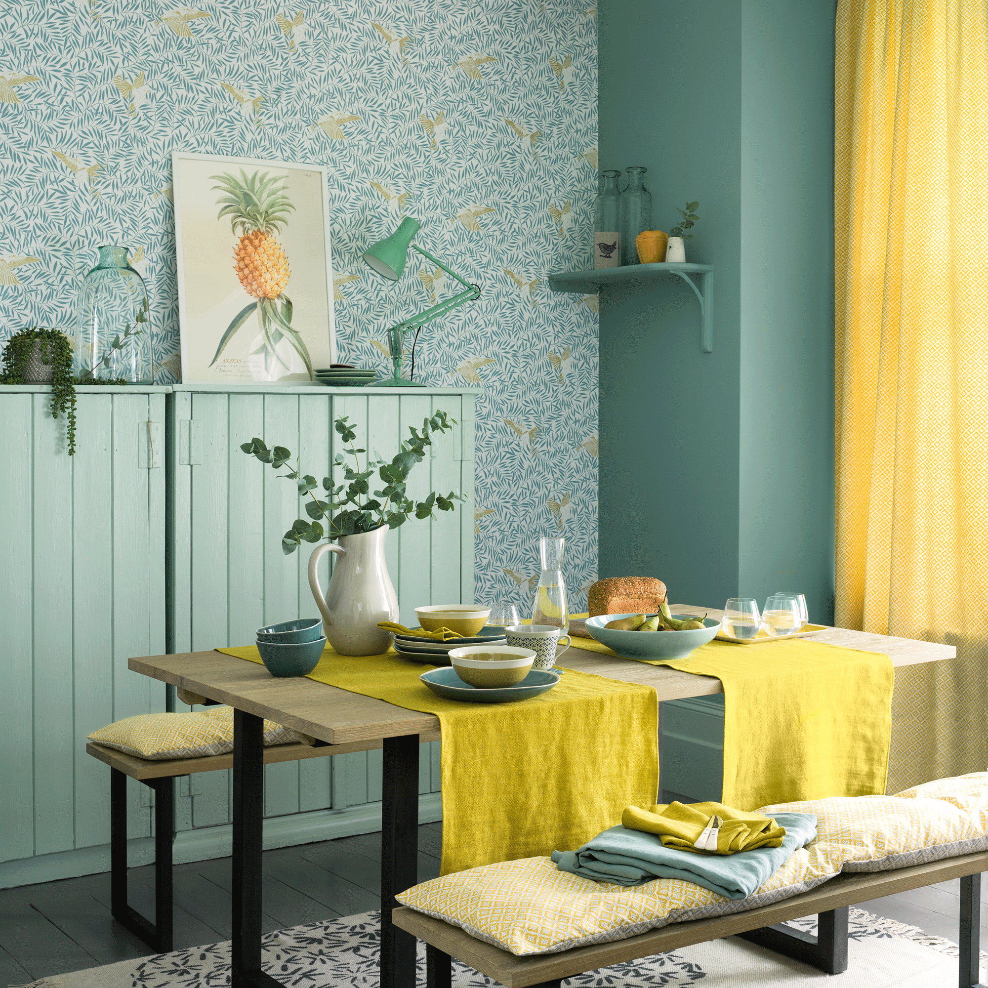 Turquoise walls with wallpaper in dining room