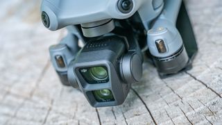 DJI Air 3 drone on a tree stump with closeup of its dual cameras