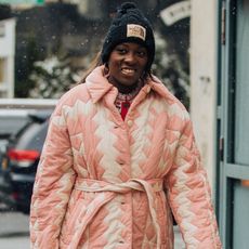 Nikki Ogunnaike wearing a hat and a coat