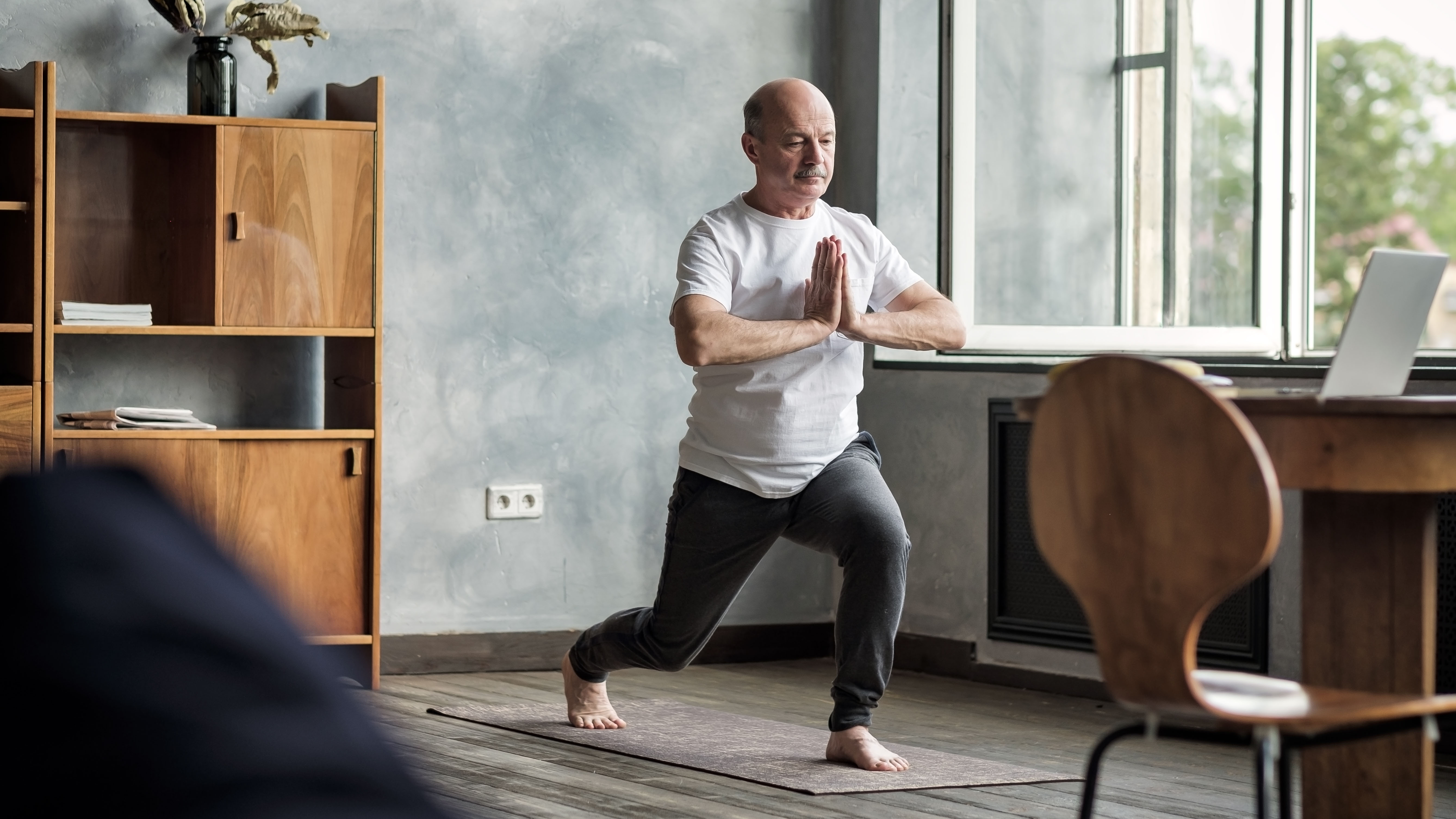 Man practicing yoga at home