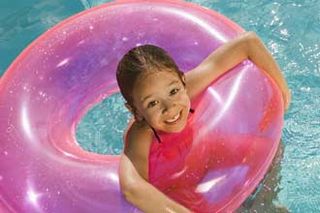 Child swimmign with rubber ring