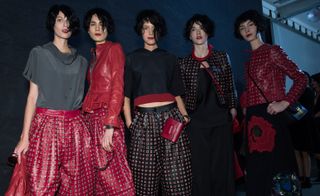 Models wearing a combination of red and black patterned wide pants, with the same color and pattern jackets, from Emporio Armani A/W 2015 collection.