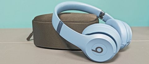 Beats Solo 4 wireless headphones resting on case
