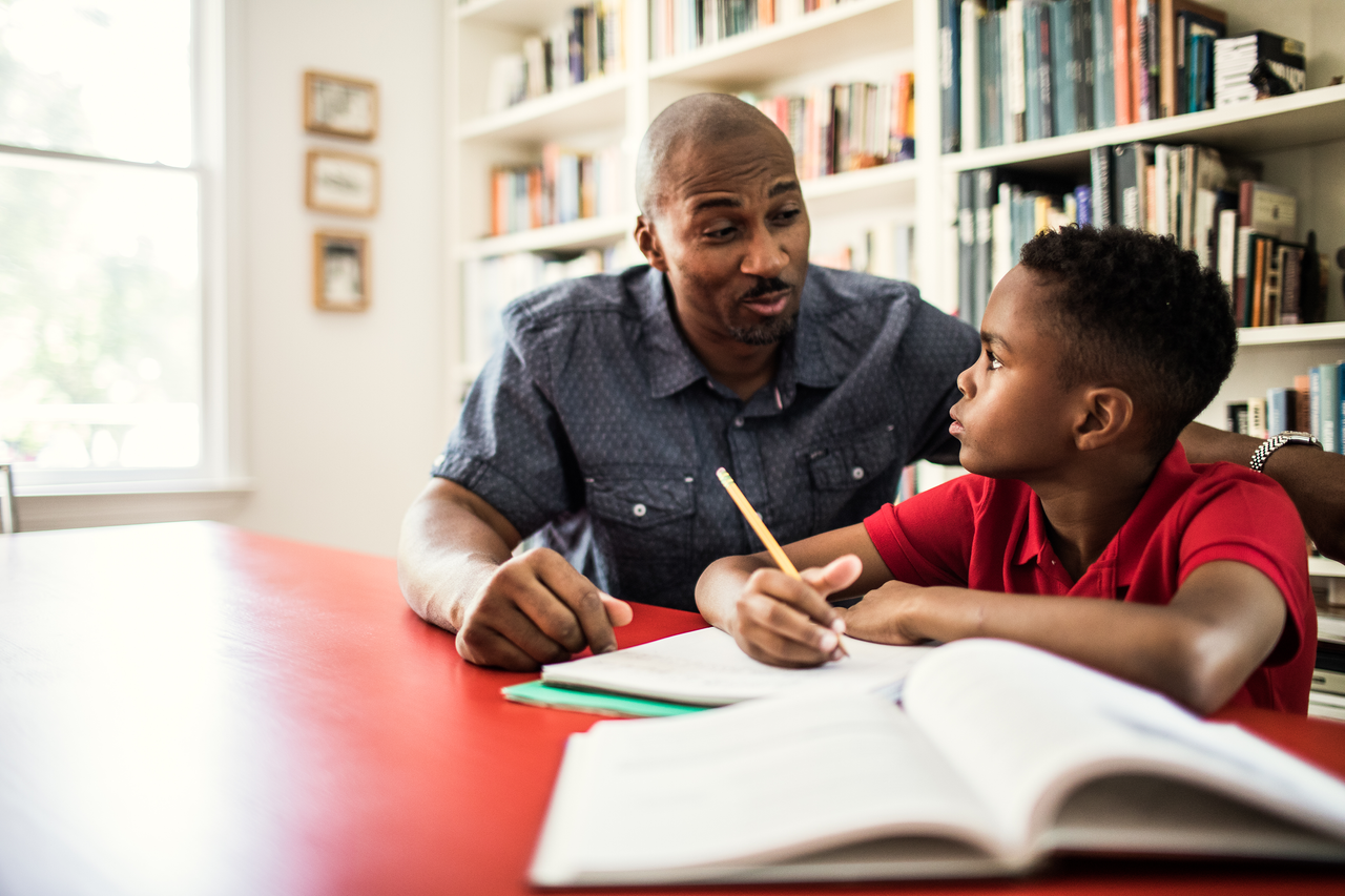 father and son homeschooling during lockdown