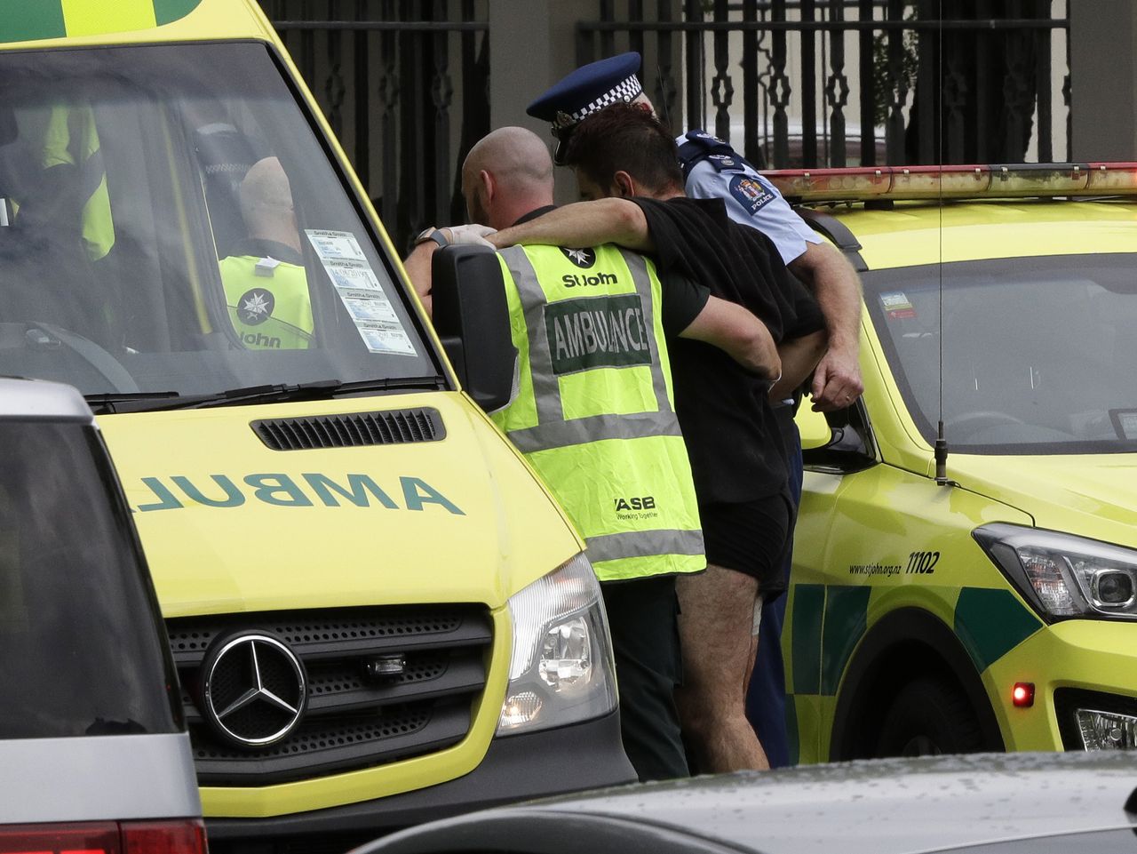 First responders help a man injured during a shooting in Christchurch.