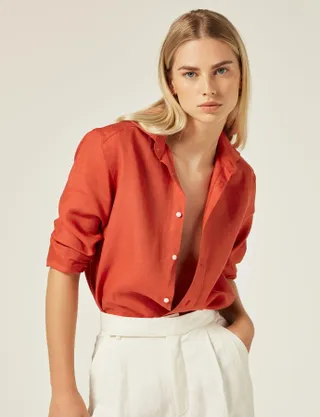 A model wears With Nothing Underneath's The Boyfriend linen shirt in Cardinal Red