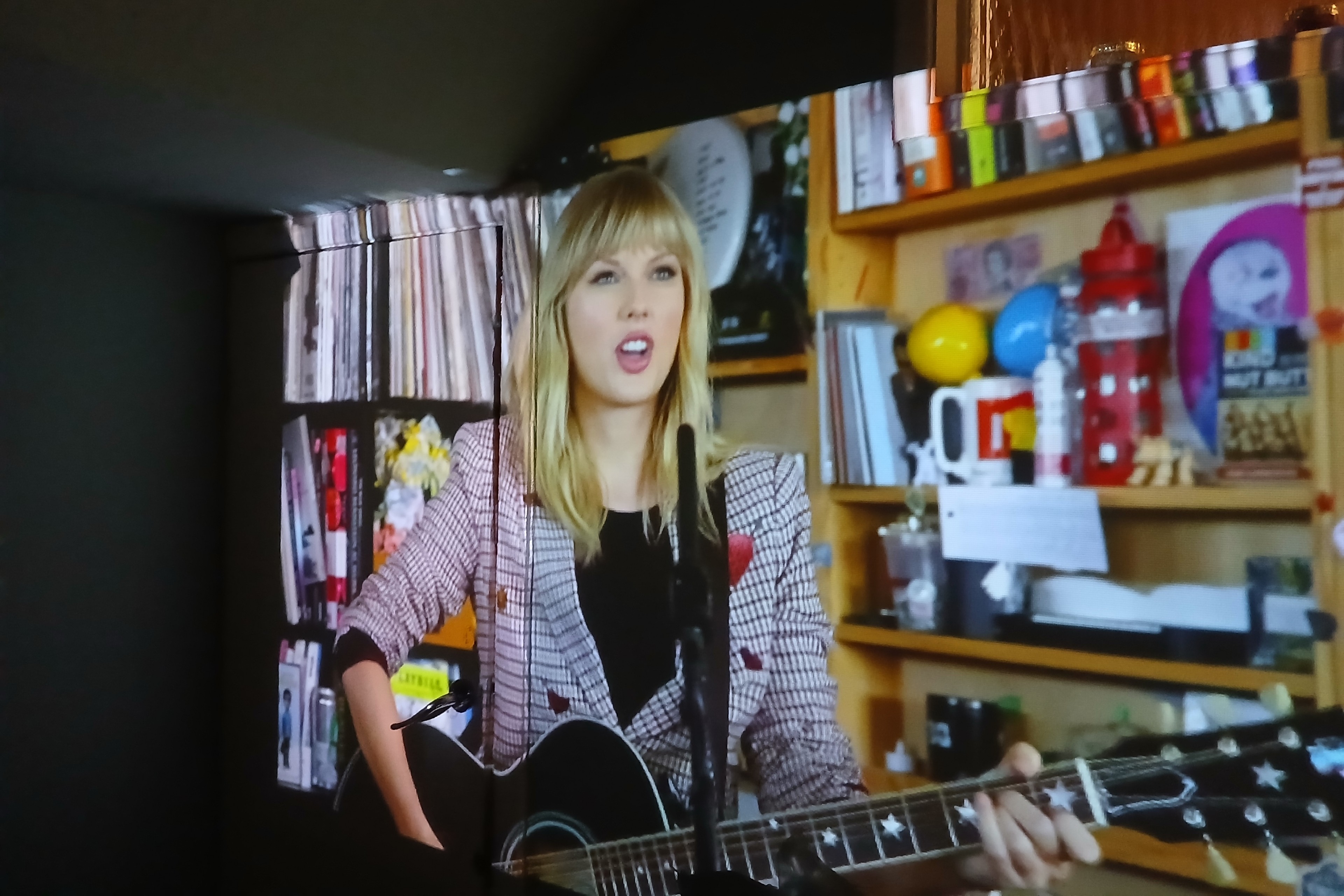 Image of Taylor Swift being projected onto a living room wall