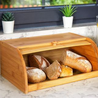 A RoyalHouse Premium Bamboo Bread Box filled with bread, sitting on a countertop