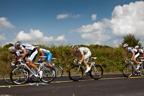 Riders go by covering whatever goes up the road.