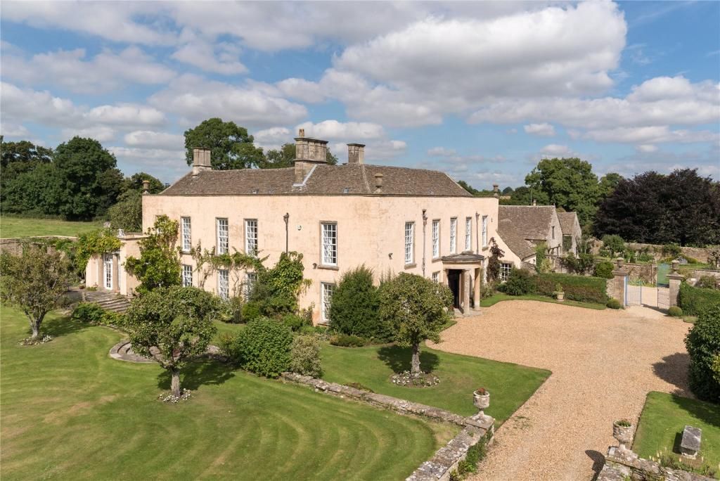 An exterior view of Luckington Court showing off its buff coloured brickwork and lawned gardens