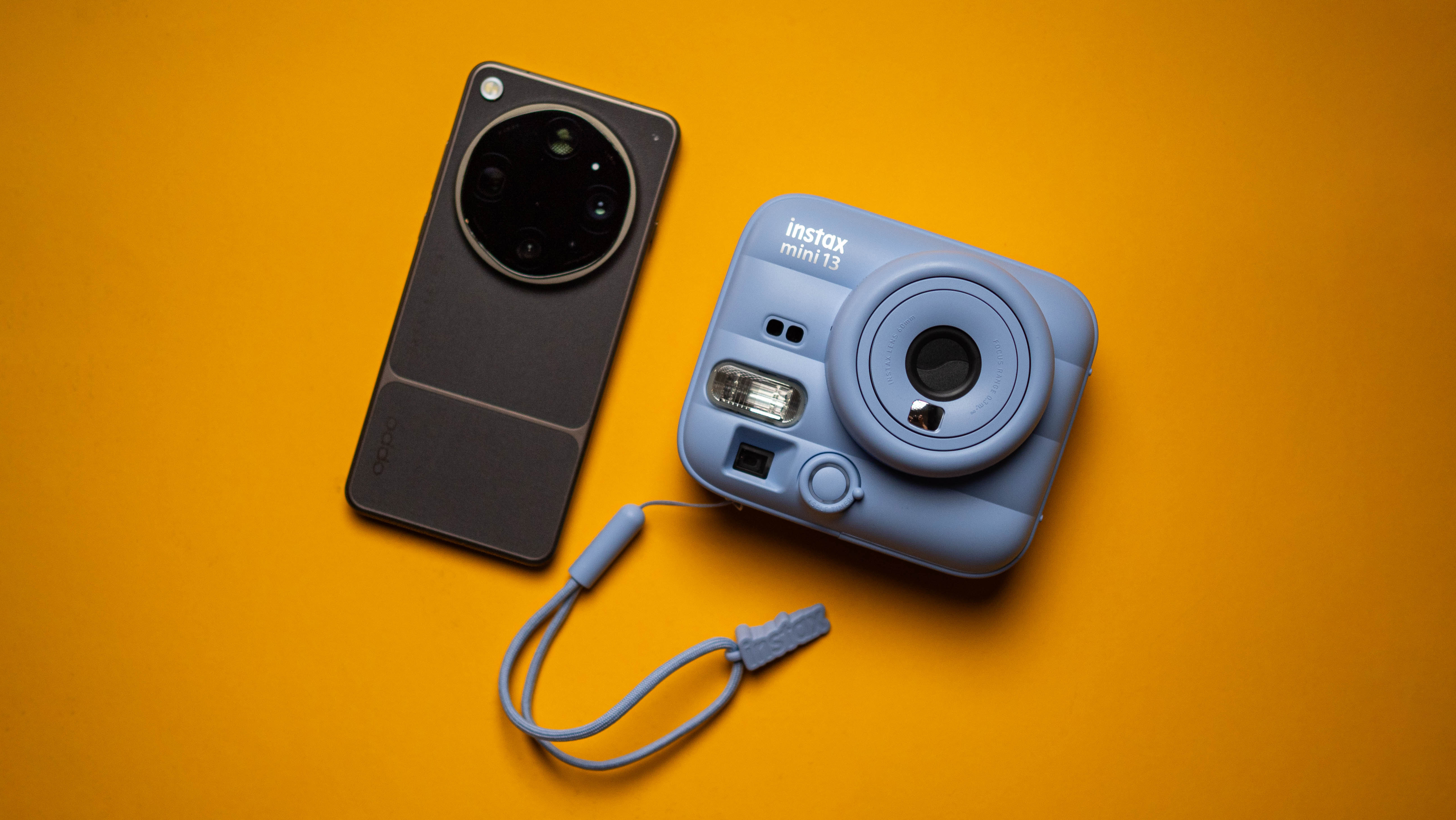 Fujifilm Instax Mini 13 instant camera against a yellow colored sheet