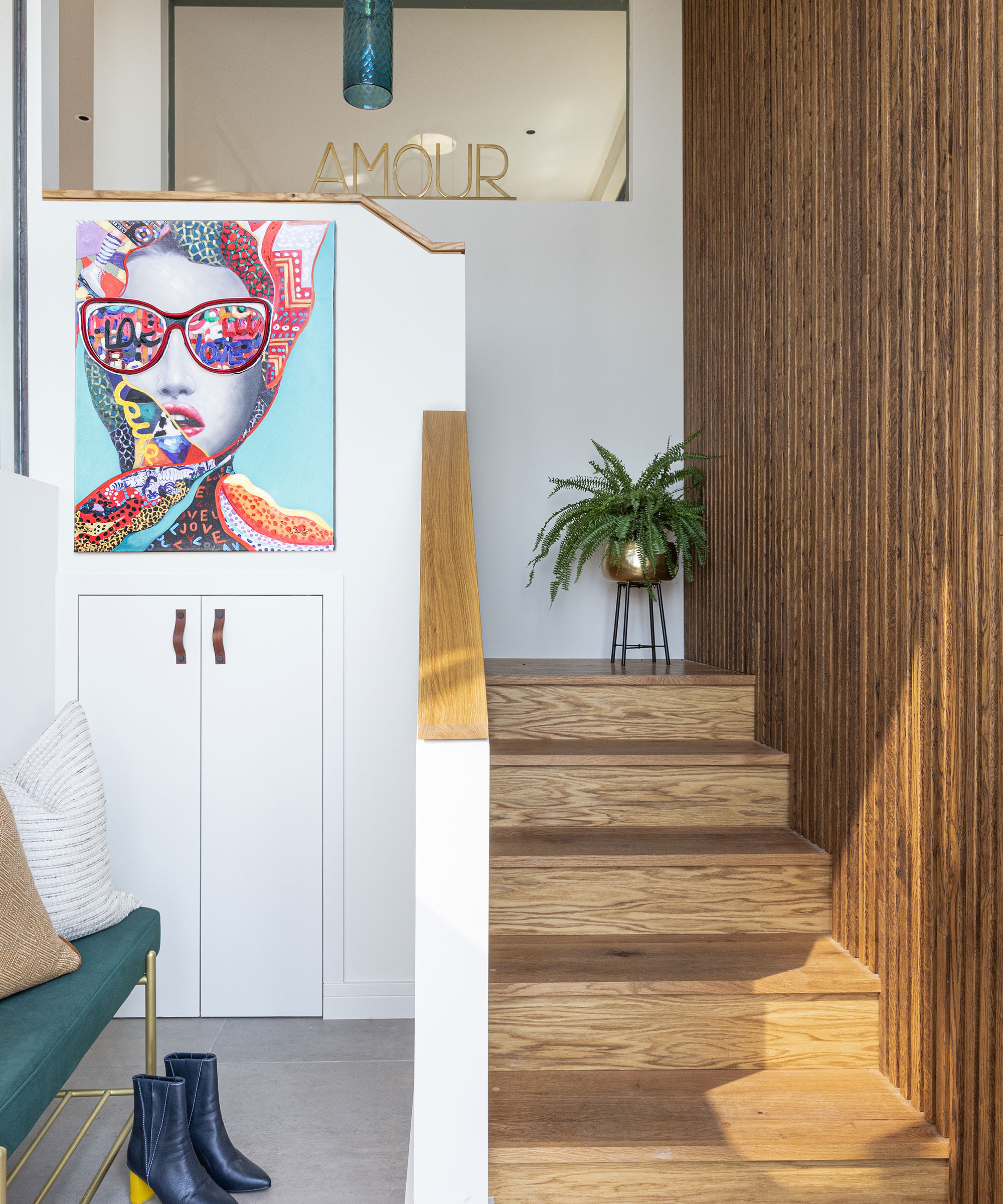 small entrance hallway with built-in storage cupboard and wooden staircase with modern wooden wall panelling