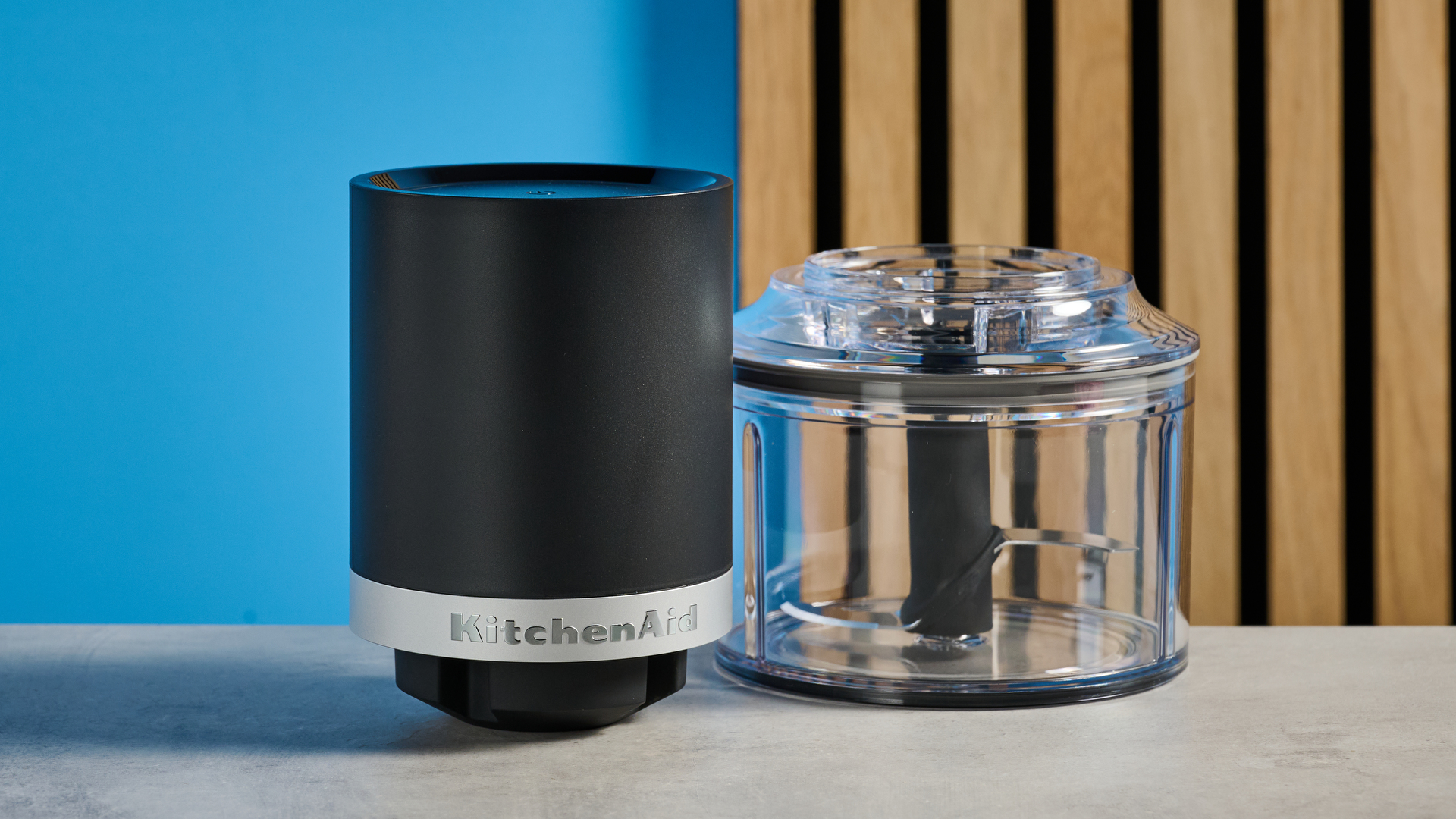 KitchenAid Cordless Top Down Food Chopper photographed in front of a blue background.