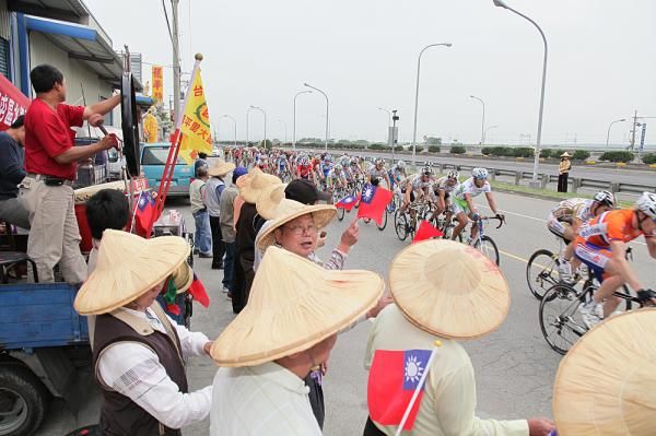 Locals enjoy watching the race speed past.