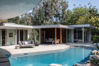 exterior with pool of cove way, a midcentury home restored by Sophie goineau