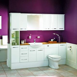 purple bathroom with white cabinet and washbasin